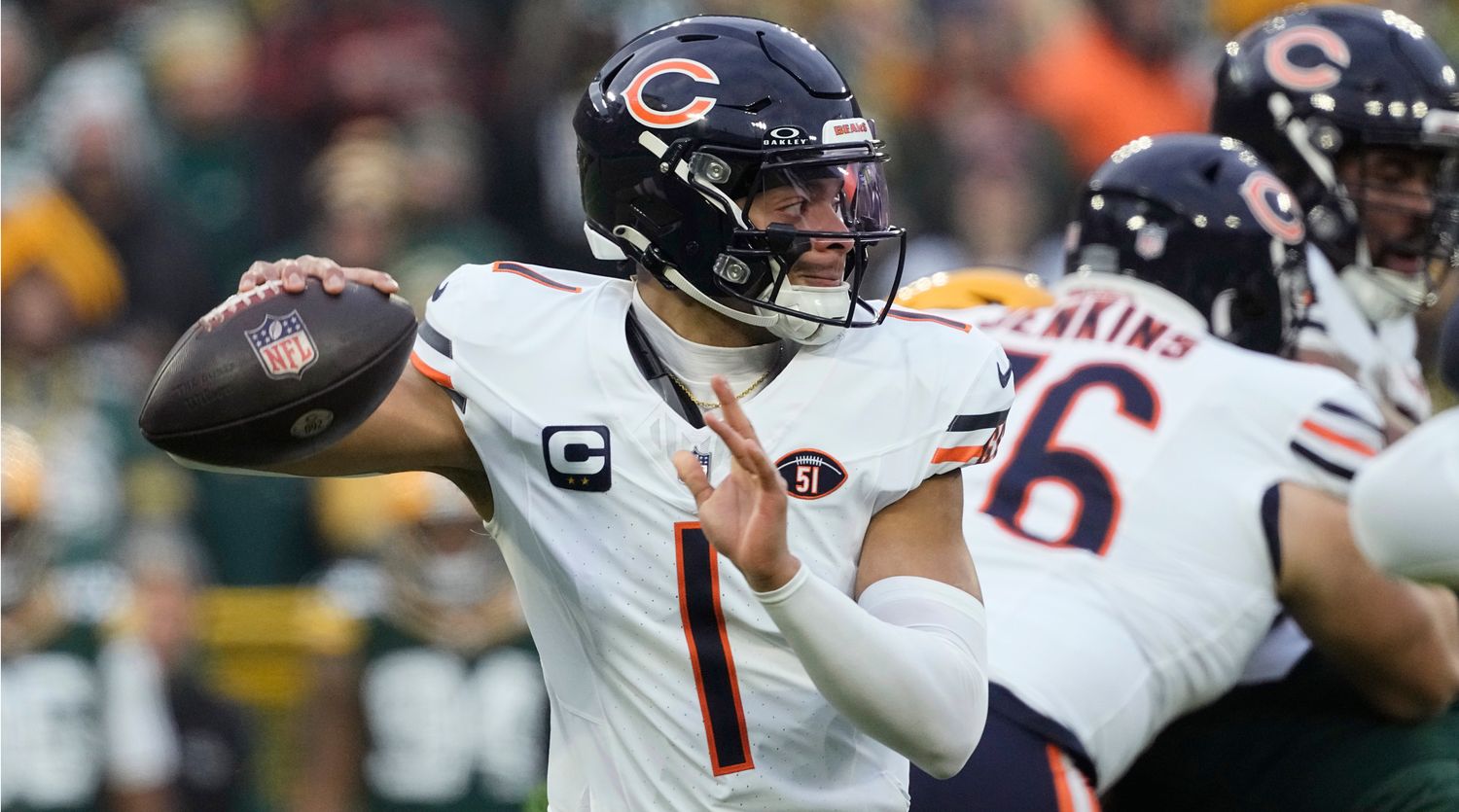 Justin Fields pulls back the football in one hand to throw